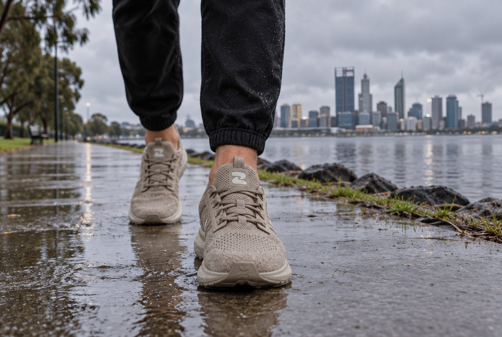 Oszea Coastal Sand sneakers on a wet Swan River path in Perth
